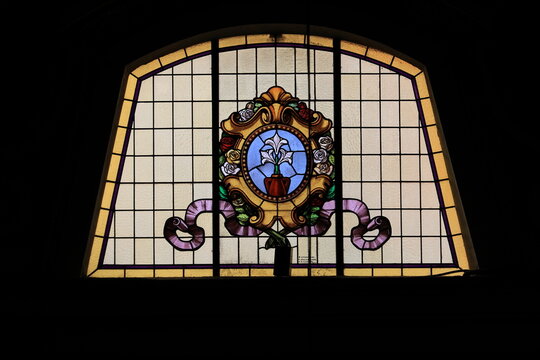 Stained Glass Window Depicting Lilies at the Santi Cosma e Damiano In Via Sacra Basilica in Rome, Italy
