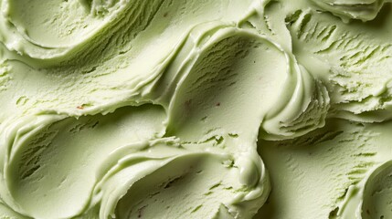 Obraz premium Gentle swathes of pale green ice cream with creamy swirls fill the frame, creating an atmospheric backdrop for dessert arrangements.