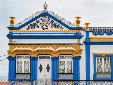 Ornate Portuguese architecture in the Terceira Island, Azores, Portugal. Small chapel Imperio do Espirito Santo de Sao Bartolomeu - Imperio do Terreiro. White building with colorful decorative details