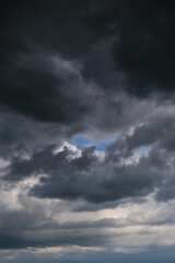 Fototapeta premium Storm cloudy sky with dark cumulus clouds and blue sky background texture, thunderstorm, heaven