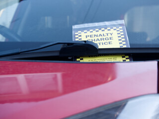 Parking ticket on windshield of car