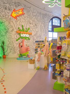 Belek, Turkey - March 30, 2026: vibrant retail interior of Nickelodeon branded store showcasing organized shelves of plushies, apparel, and iconic cartoon murals for fun family shopping experience