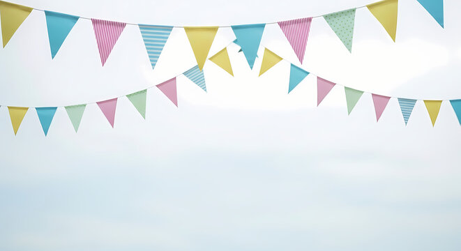 Colorful festive bunting flags against a clear blue sky