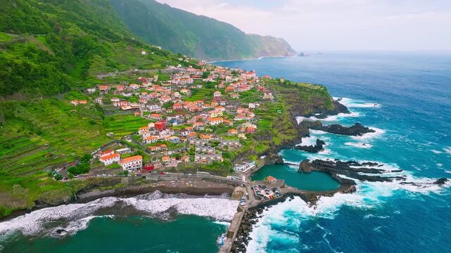 Aerial drone shot of Seixal village on Atlantic ocean coast on Madeira island, Portugal. Tilt shot