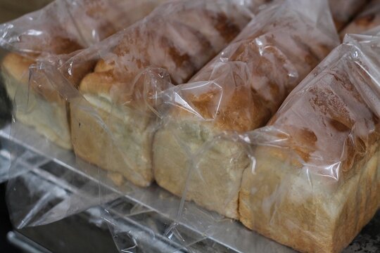 Fresh Sliced Loaves Of White Bread Packaged In Plastic