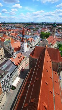 Vertical static video shot looking down on the Altes Rathaus and the red roofs of central Munich, Bavaria, Germany.