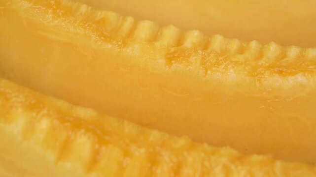 Extreme Macro Close-up of Fresh Juicy Cantaloupe Melon Slices with Ridged Texture on Orange Background, Food Ads