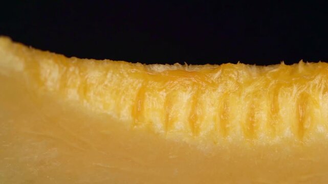 Extreme Macro Close-up of Fresh Juicy Cantaloupe Melon Slice with Ridged Texture on Black Background, Food Ads