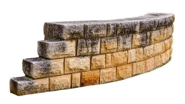 Curved retaining wall made of stacked rough textured stone blocks, isolated on transparent background