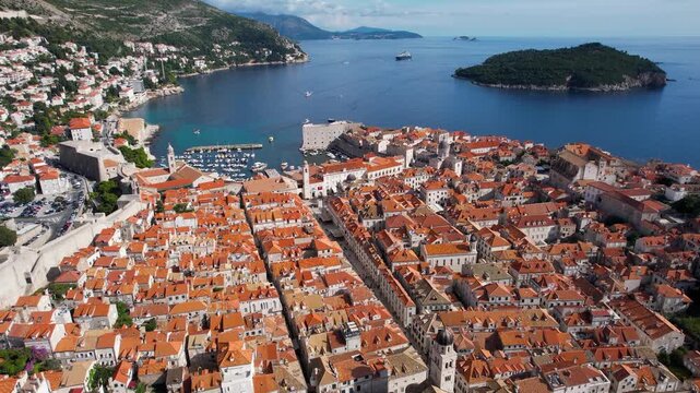 Aerial view of the terracotta rooftops of Dubrovnik's Old Town meeting the Adriatic sea, showcasing the city's historical architecture, Dubrovnik, Dubrovnik-Neretva County, Croatia.