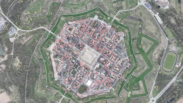 Aerial view of the historic star fort with red-roofed buildings and green moats creating a striking contrast, Neuf-Brisach, Grand Est, France.