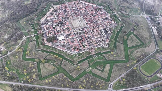 Aerial view of the star-shaped fortress of Neuf-Brisach, an octagonal grid of red rooftops and green moats, a testament to military architecture, Neuf-Brisach, Grand Est, France.