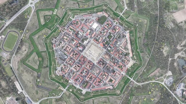 Aerial view of the star-shaped fortress of Neuf-Brisach, with its unique pattern of streets and buildings, surrounded by vibrant green fields, Neuf-Brisach, Grand Est, France.