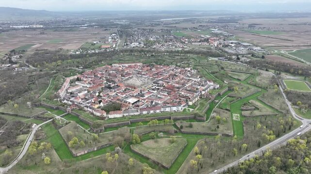 Aerial view of the star-shaped fortress of Neuf-Brisach, with its red-roofed buildings and green surroundings, Grand Est, France.