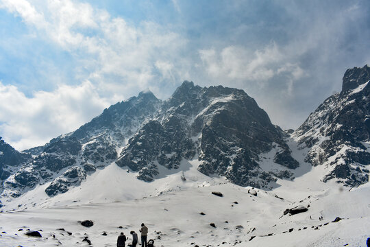 Dramatic snow-covered Himalayan peaks(Kala Patthar) with rugged cliffs under cloudy sky in high altitude North Sikkim landscape.