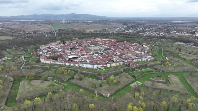 Aerial view of the octagonal fortress of Neuf-Brisach, with its red rooftops surrounded by green grass and trees, Neuf-Brisach, Grand Est, France.