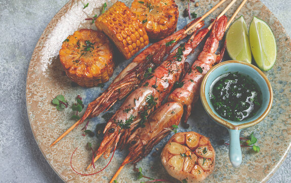 langoustines on skewers, shrimp kebab, with fried corn, spices and herbs, homemade, no people,