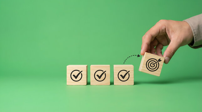 Hand placing wooden cube with target icon next to cubes with checkmarks