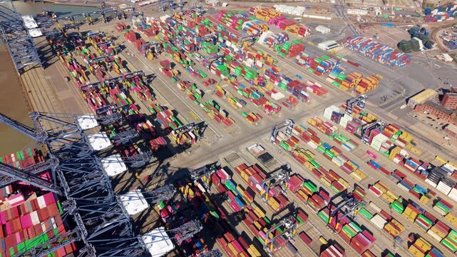 Aerial view of colorful shipping containers and cranes creating a geometric pattern in the port, a hive of activity, Port of Felixstowe, Felixstowe, United Kingdom.