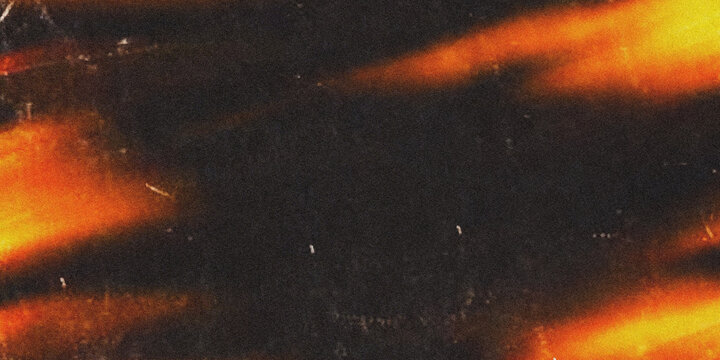 A dark background with vibrant orange and yellow lights shining through