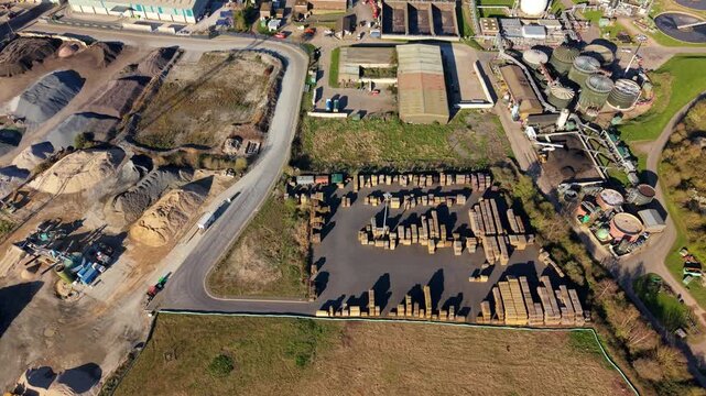 Aerial view of ABP's Port of Ipswich, where stacks of timber meet silos, creating a tapestry of industry against the English landscape, Ipswich, England, United Kingdom.