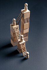 Career Progression and Leadership Hierarchy Concept with Wooden Figures and Block Ladders