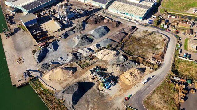 Aerial view of ABP's Port of Ipswich shows an industrial landscape with piles of materials, buildings, and waterways, Ipswich, England, United Kingdom.