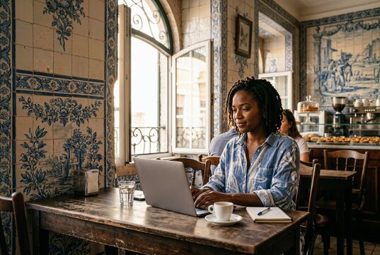 Digital Nomad Working on Laptop in Portuguese Azulejo Cafe