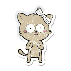 Fototapeta premium Distressed sticker of a cute cartoon green cat with a white bow and wide eyes