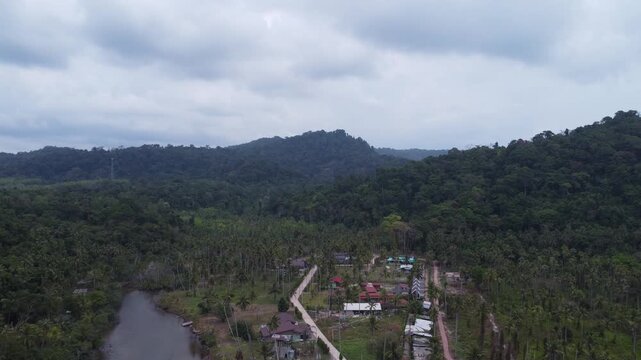 Drone aerial capturing the idyllic shoreline of We Ao Park Bay on Koh Kood, where turquoise sea and tropical jungle meet in a peaceful island setting.