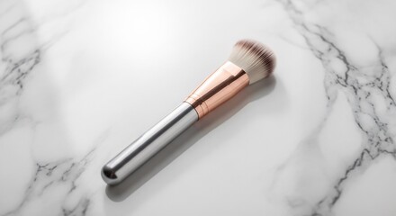 Fototapeta premium Elegant Makeup Brush with Rose Gold Handle on Marble Surface.