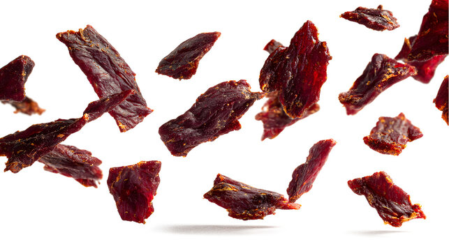 Beef jerky pieces in the air isolated on a white background