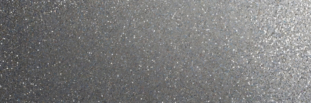 A high resolution texture of shimmering silver glitter and sequins reflecting light with a subtle gradient effect
