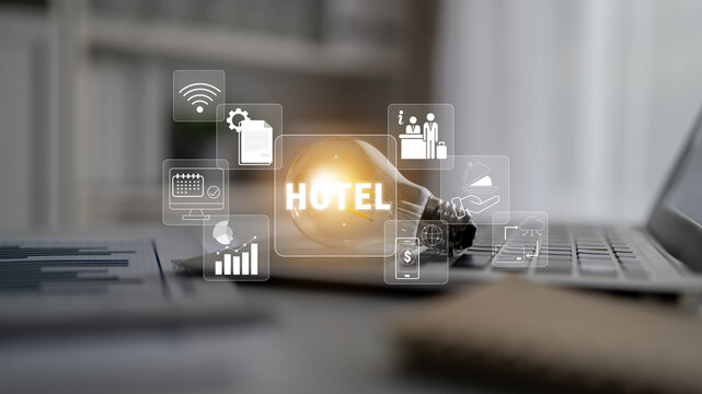 Conceptual image of hotel management with light bulb and digital icons representing technology, services, and innovations in the hospitality sector Quark.