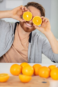 excited man playing with orange