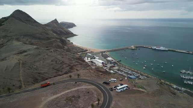 Aerial drone view over the port of Vila Baleira, a small town in Porto Santo island, Madeira, Portugal. Long golden beach with transprent water.