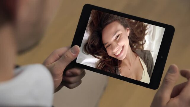 Romantic distant couple call tab at apartment closeup. Man hands holding tablet