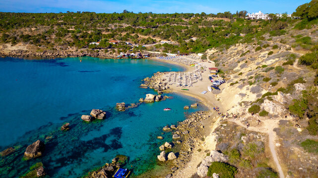 yia Napa sea caves area featuring hidden cove with turquoise water and rocks. Secluded beach spot surrounded by natural formations and crystal clear shallow sea