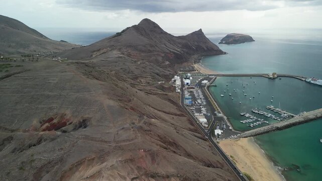 Aerial drone view over the port of Vila Baleira, a small town in Porto Santo island, Madeira, Portugal. Long golden beach with transprent water.