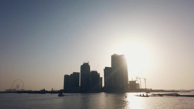 Vibrant Dubai Marina Skyline at Sunset with Skyscraper Construction