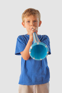 A child with a light blue and white vuvuzela. Isolated.