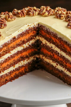 A single slice of carrot cake on a white plate, ready for serving