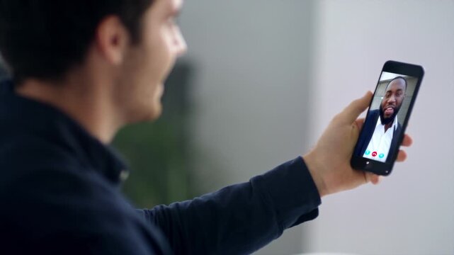 Startuper video calling partner using smartphone web chat remotely close up. 