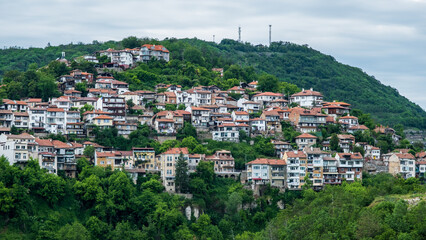 Fototapeta premium Terraced Traditional Houses Clustered on a Steep Hillside in Bulgaria