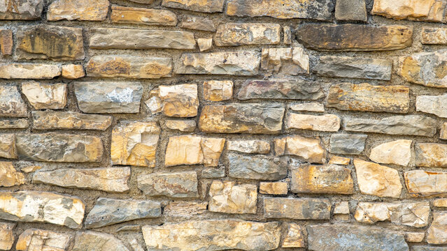 Close-up Texture of Old, Varied Fieldstone Masonry Wall
