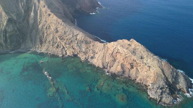 Aerial drone view of stunning volcanic landscape in Porto Santo island, Madeira, Portugal. Old volcano and high mountains with natural beaches