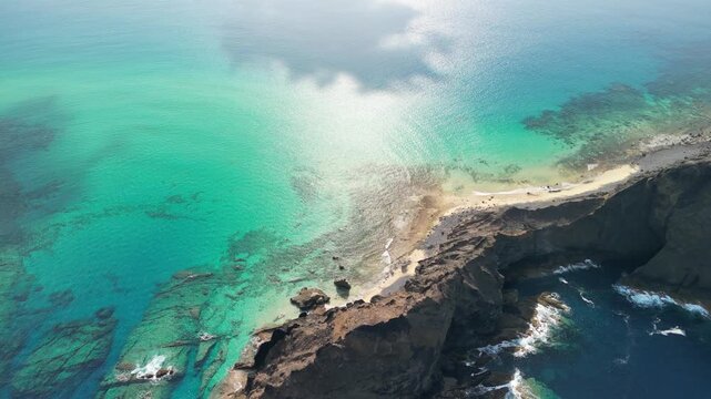 Aerial view of Ilheu da Cal, Porto Santo island, Madeira, Portugal. Tiny island drone reveal. Paradise with transparent water