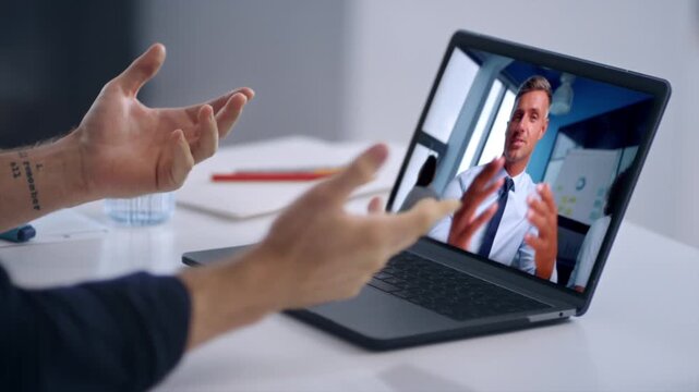 Two businessmen talking videoconference laptop in office close up. Video call
