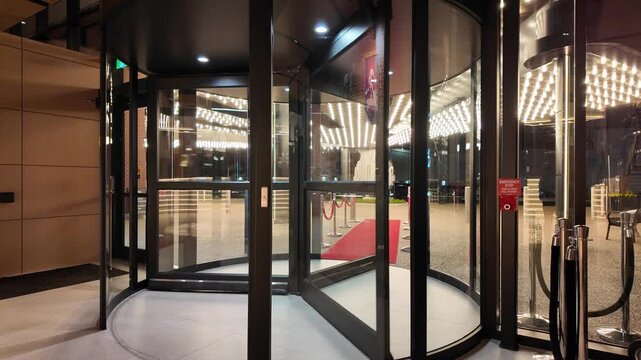 Revolving Door Entrance at Luxury Hotel With Red Carpet Outside