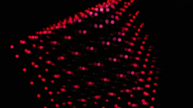 A cube of red dots on a black monitor screen rotates in all directions.with dynamic shapes and designs emerging
